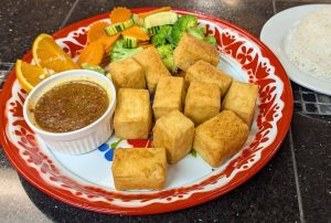Crispy Tofu Crispy tofu from Tasty Thai Tempe with steamed vegetables and choice of Thai sauces near South Tempe.
