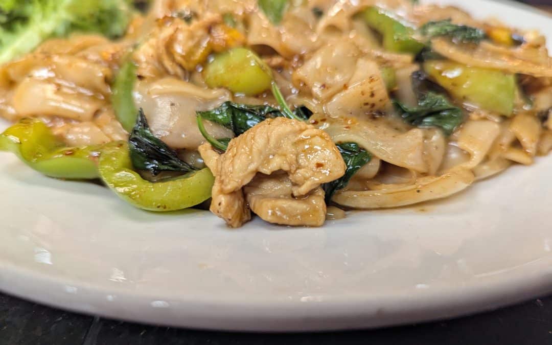 Drunken noodles from Tasty Thai Tempe with wide rice noodles, basil, and bell peppers in a spicy Thai sauce near downtown Tempe.