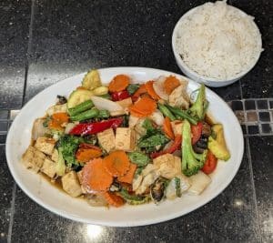 Vegetable Delight with tofu and mixed vegetables, served with a bowl of rice at Tasty Thai Tempe.
